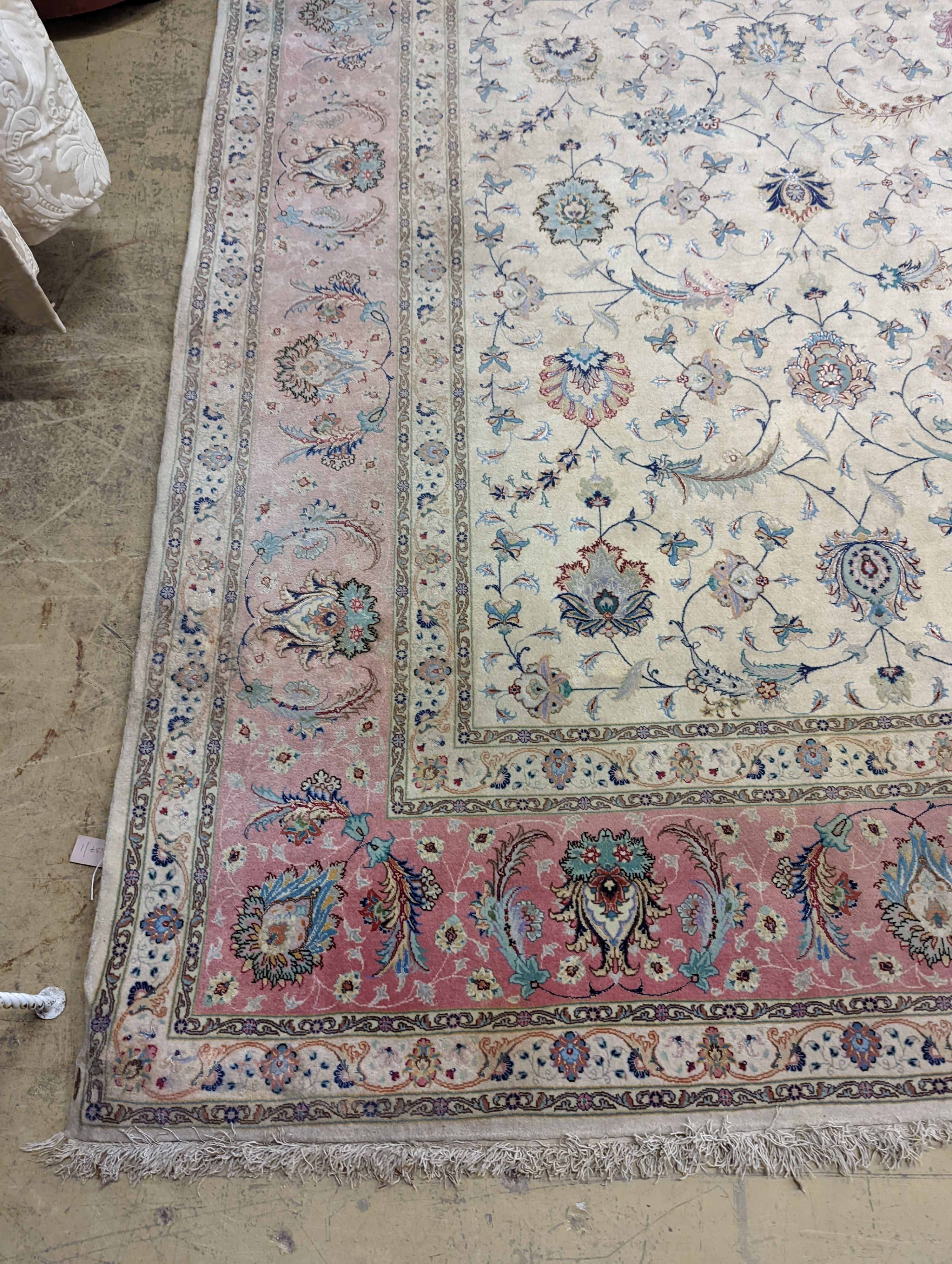 A Persian Tabriz ivory ground carpet, 410 x 300cm